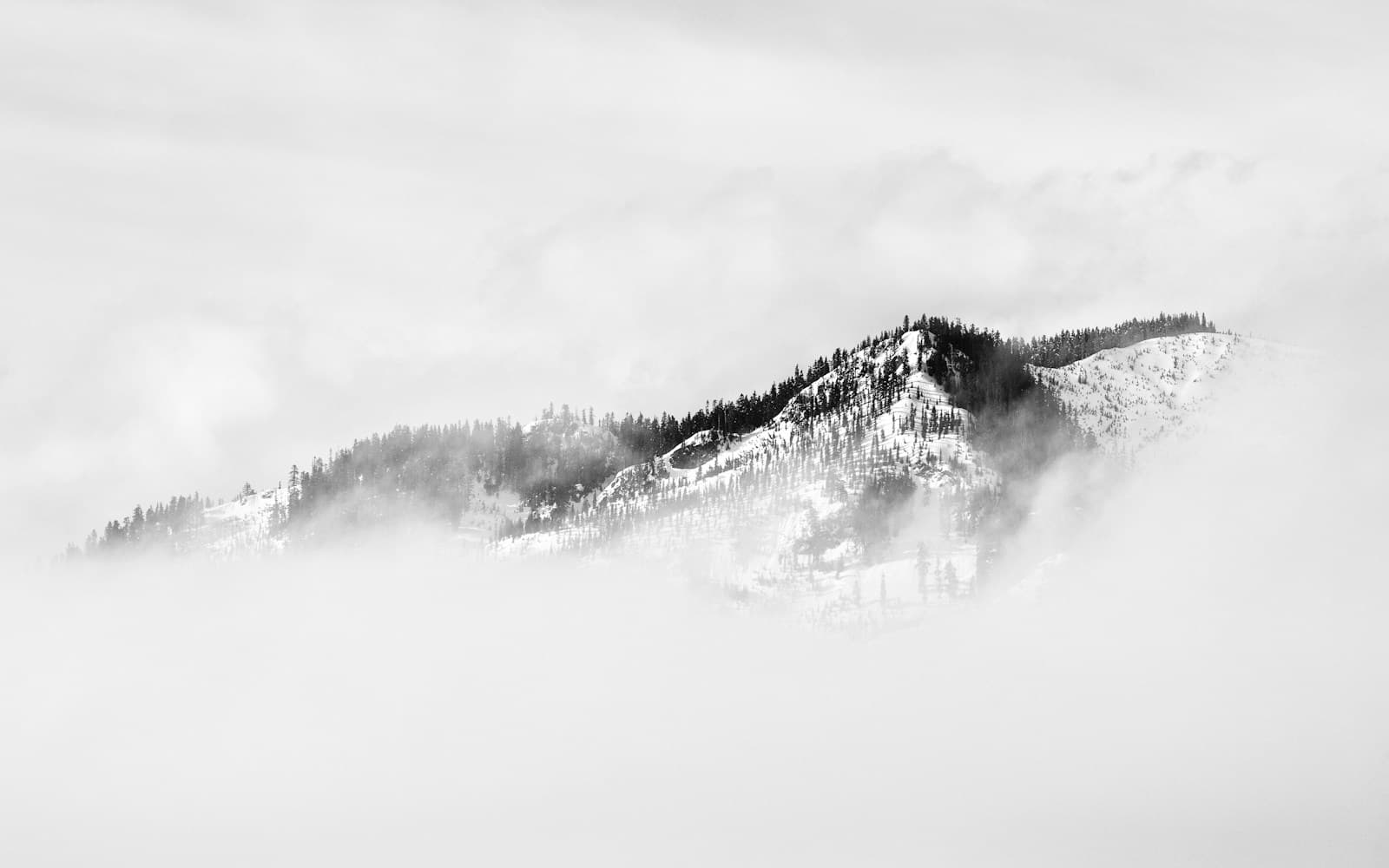 A mountain peak obscured by cloud and mist